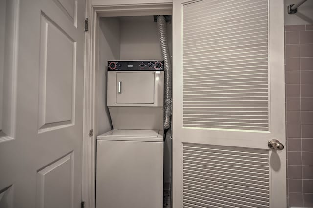 laundry room featuring laundry area and stacked washer and clothes dryer