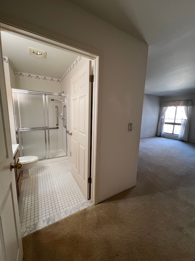 bathroom with tile patterned floors, visible vents, a shower stall, and toilet