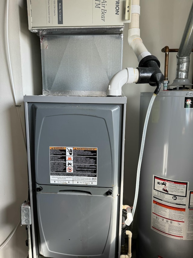 utility room featuring water heater