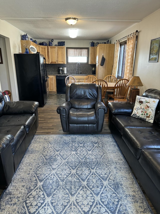 living room with a textured ceiling and wood finished floors