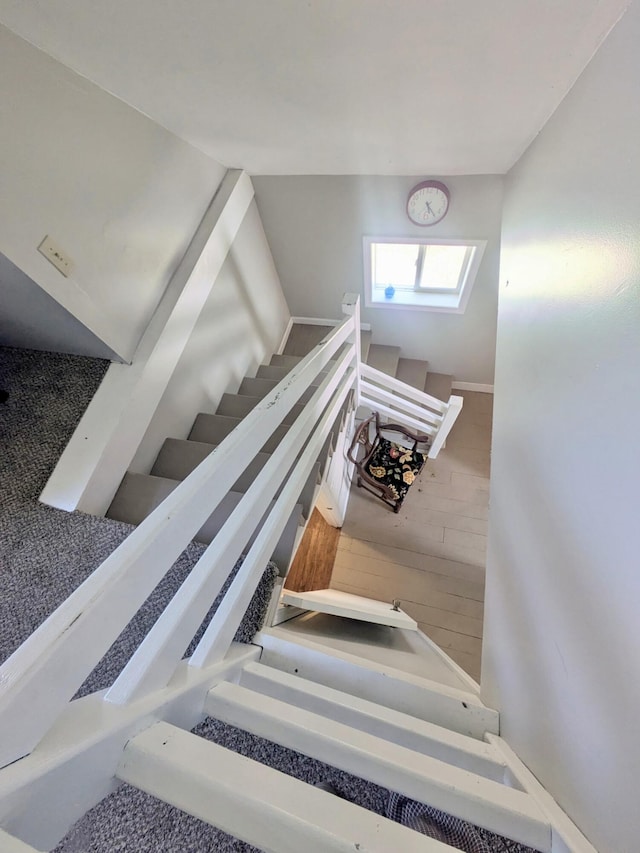 staircase featuring wood finished floors