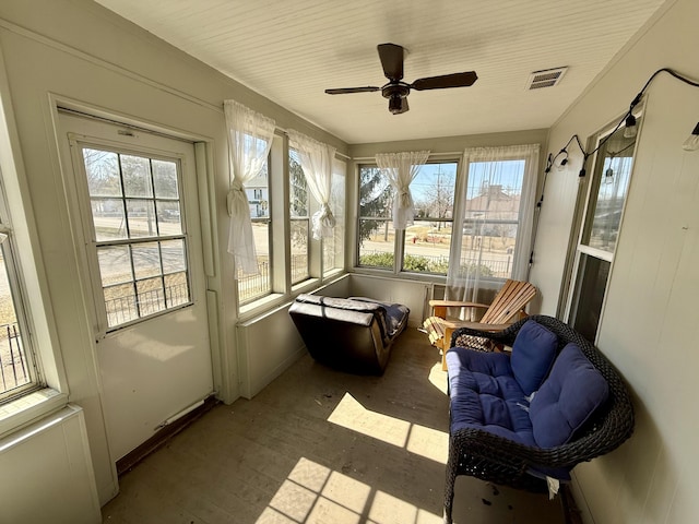 sunroom featuring visible vents and ceiling fan