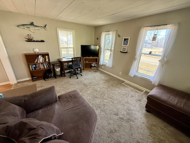 living room with visible vents, baseboards, wooden ceiling, and carpet flooring