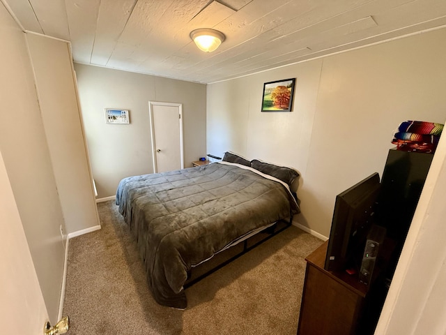 bedroom with baseboards and carpet floors