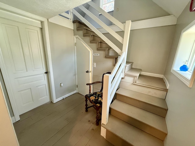 staircase featuring hardwood / wood-style flooring