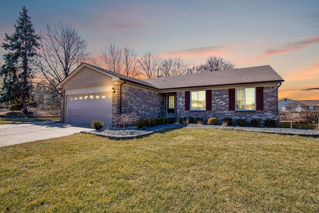 ranch-style house with brick siding, concrete driveway, roof with shingles, a lawn, and a garage