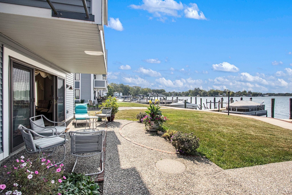 400 Lakeview Ct Unit 1A, Spring Lake, MI 49456 - view of patio with a water view and a boat dock