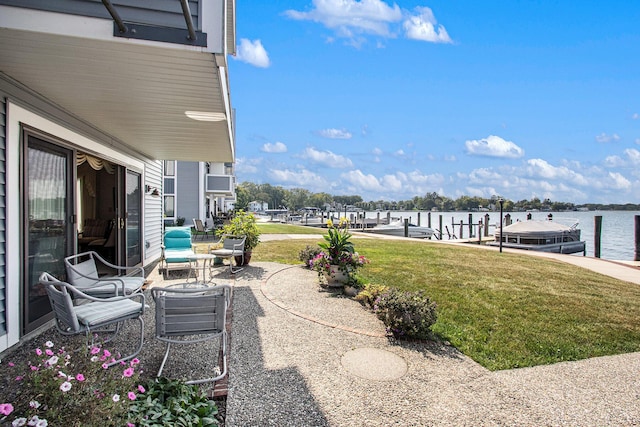 view of patio with a water view and a boat dock