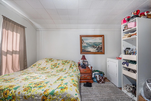 bedroom with washer and dryer and vaulted ceiling