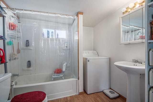 full bathroom with washer / clothes dryer, toilet, shower / washtub combination, and wood finished floors