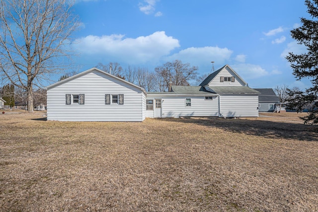 rear view of house with a yard