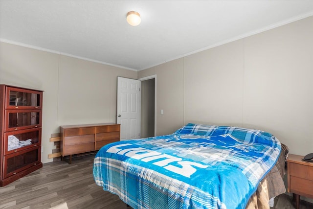 bedroom featuring wood finished floors and ornamental molding