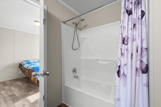 bathroom featuring shower / tub combo, ornamental molding, wood finished floors, and a textured ceiling