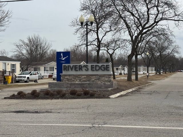 community / neighborhood sign featuring a residential view