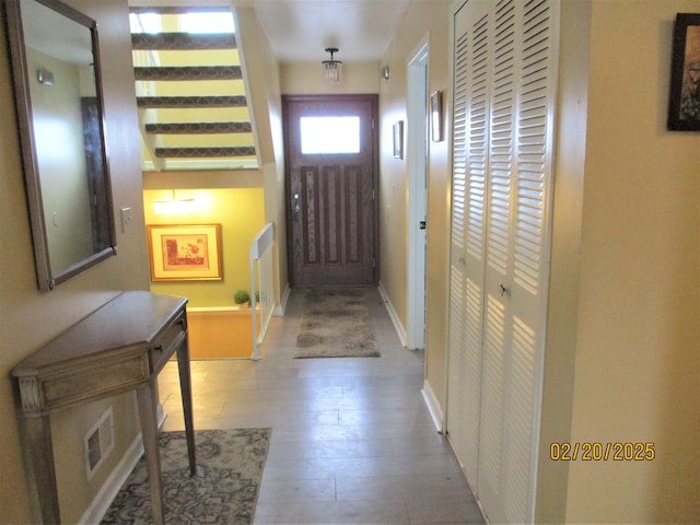 entryway featuring visible vents, wood-type flooring, and baseboards