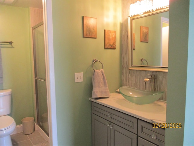 bathroom with a shower stall, baseboards, toilet, tile patterned floors, and vanity