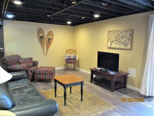 living room featuring wood finished floors and baseboards