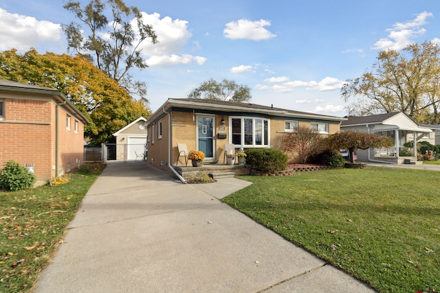 view of front of home with a front lawn, fence, brick siding, and an outdoor structure