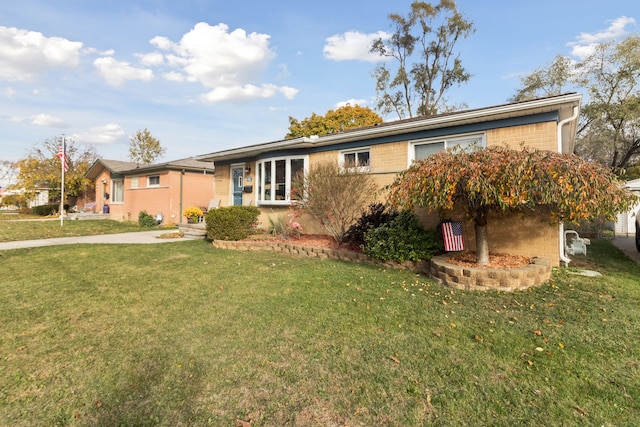 single story home with a front lawn and brick siding