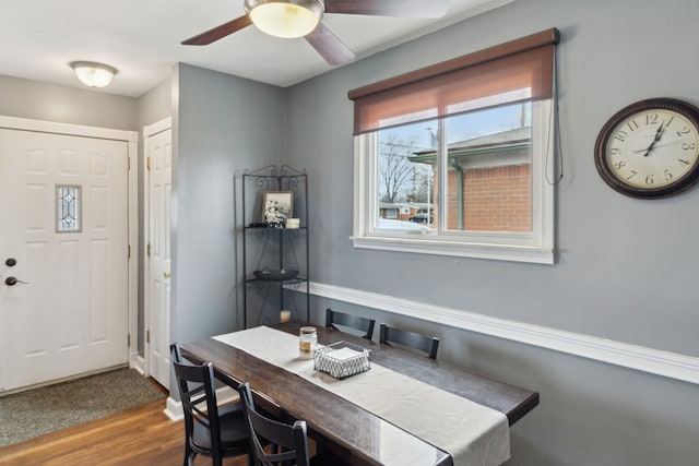 dining space with ceiling fan and wood finished floors