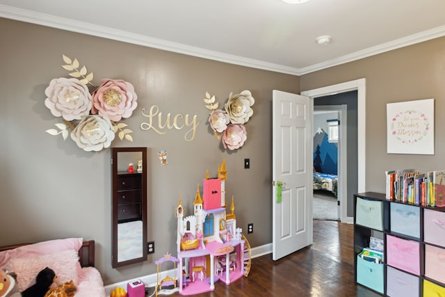 recreation room featuring baseboards, wood finished floors, and ornamental molding