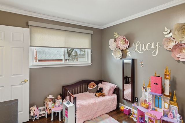 bedroom with wood finished floors and ornamental molding