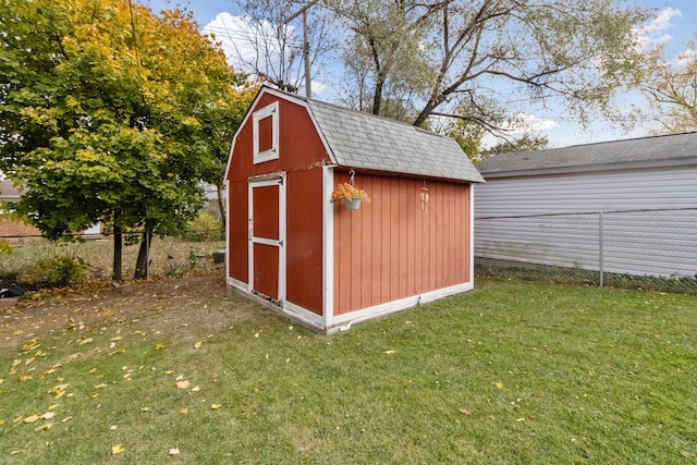 view of shed featuring fence