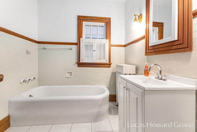 bathroom with a bath, tile patterned flooring, tile walls, and vanity