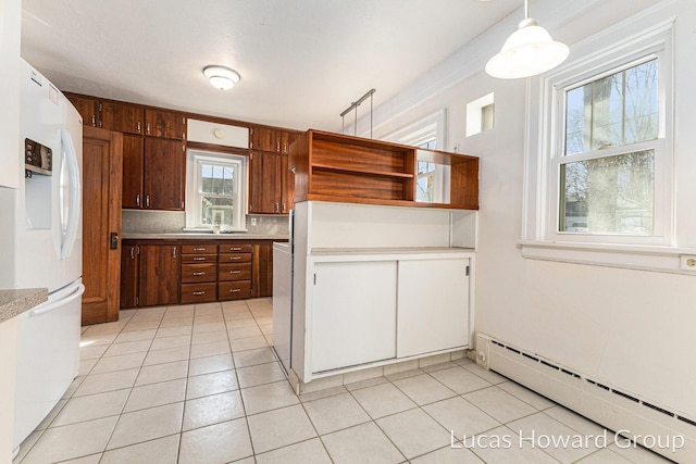 kitchen featuring open shelves, a baseboard heating unit, backsplash, white refrigerator with ice dispenser, and light countertops