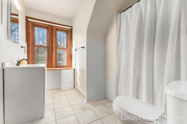 full bathroom featuring tile patterned flooring, toilet, and vanity