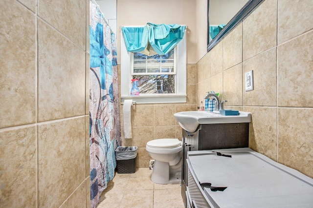 bathroom with tile patterned floors, toilet, a shower with shower curtain, tile walls, and vanity