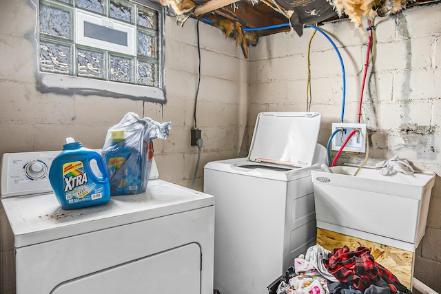 laundry room featuring laundry area, washer and dryer, and a sink