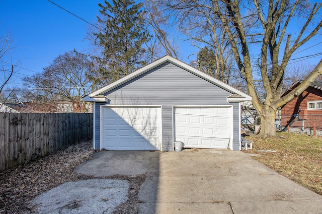 detached garage featuring fence