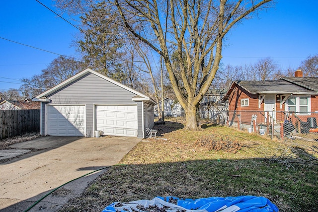 view of yard with a garage, an outdoor structure, and fence