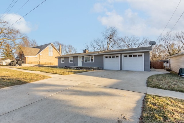 ranch-style house with a chimney, driveway, an attached garage, and a front yard