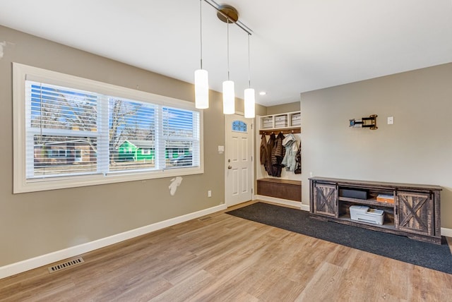 entrance foyer featuring wood finished floors, visible vents, and baseboards