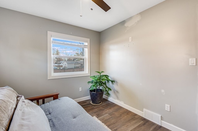 bedroom featuring visible vents, a ceiling fan, baseboards, and wood finished floors