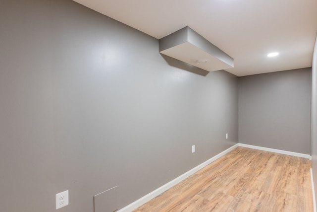 unfurnished room featuring baseboards and light wood-style flooring