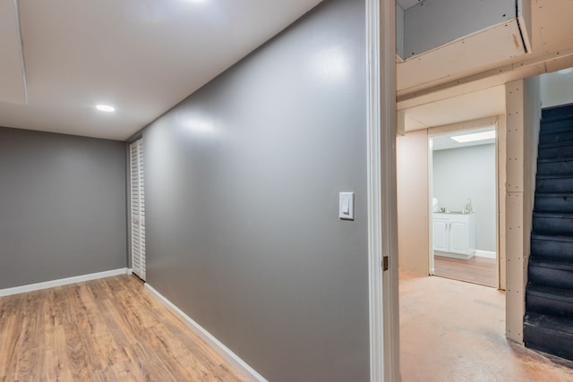 corridor featuring stairway and baseboards