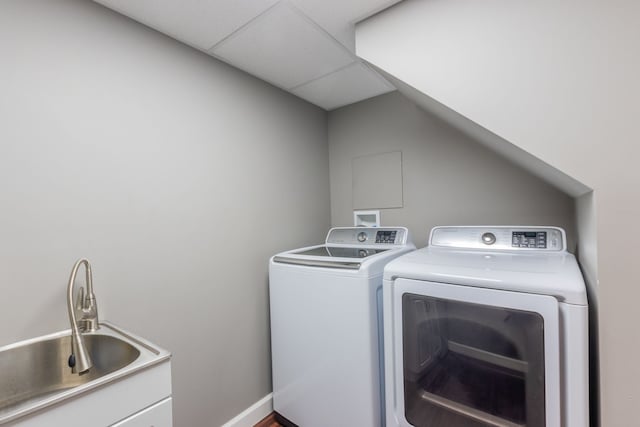 laundry room featuring laundry area, independent washer and dryer, and a sink