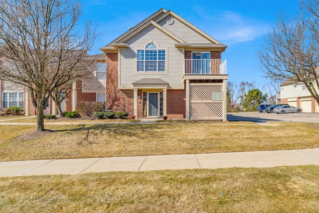 view of front of house featuring brick siding and a front lawn