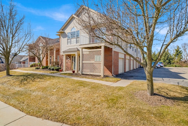 view of front of house with a front yard and brick siding