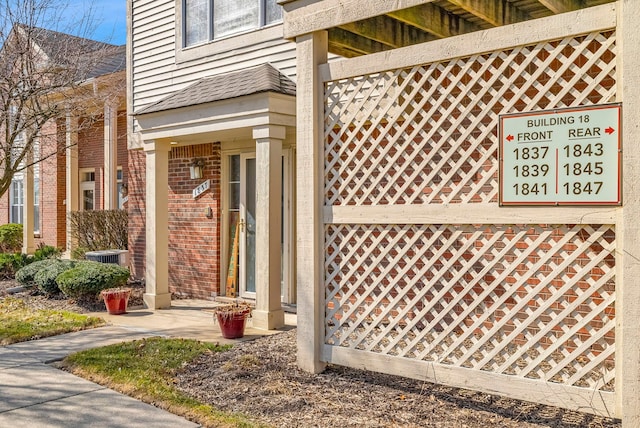 doorway to property with brick siding