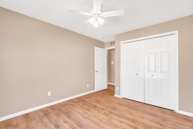 unfurnished bedroom with visible vents, a ceiling fan, a closet, light wood finished floors, and baseboards