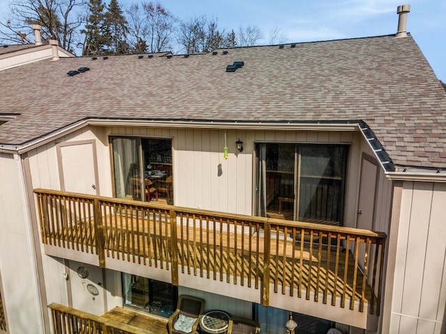 back of house with a shingled roof