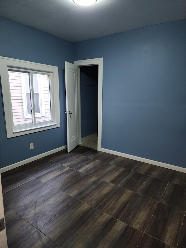 unfurnished room featuring baseboards