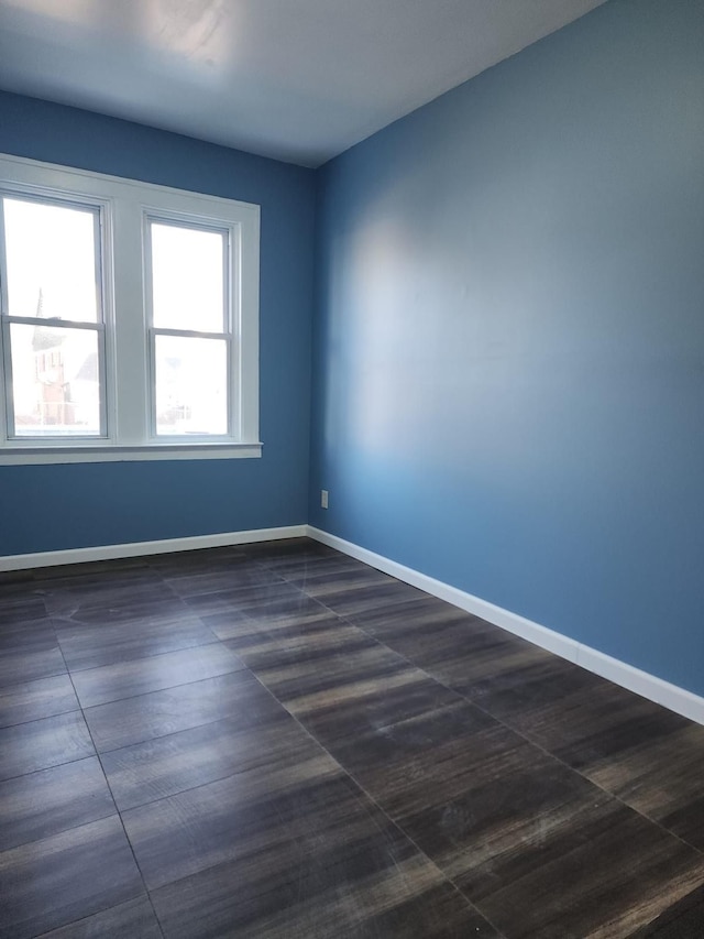 empty room featuring baseboards