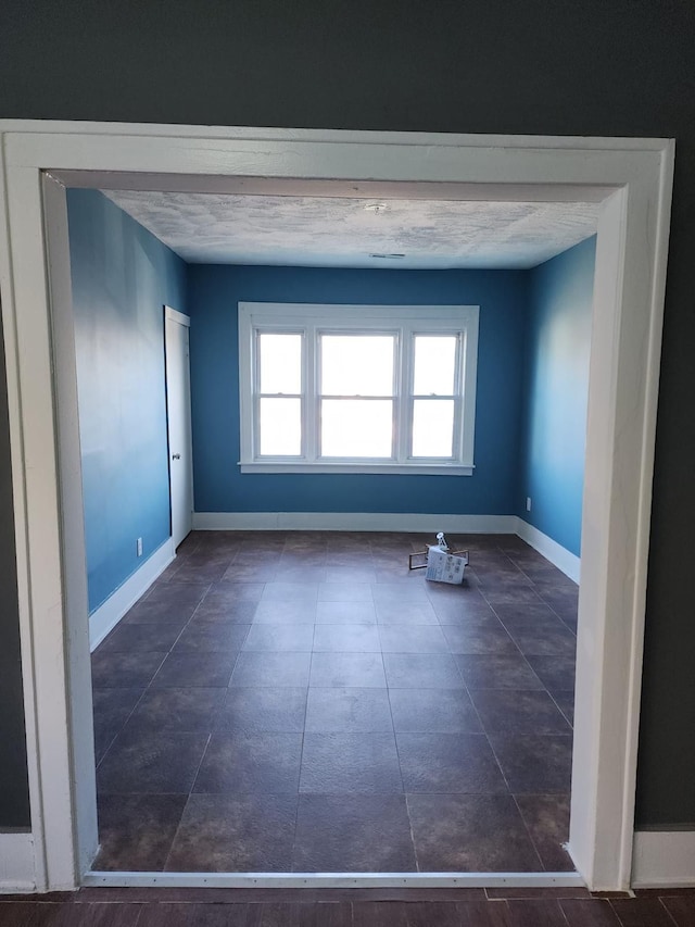 empty room featuring baseboards