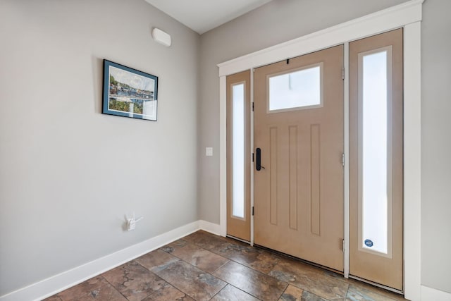 entryway featuring baseboards and stone finish flooring