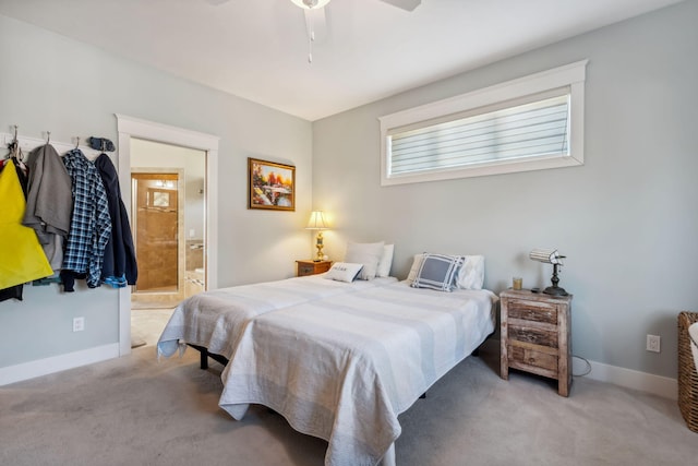 bedroom with connected bathroom, baseboards, and carpet floors